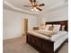 Spacious bedroom boasts a ceiling fan, large bed, and ensuite bathroom at 2737 Casper Creek Ln, Raleigh, NC 27616