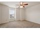 Bedroom with neutral carpet and a window features a ceiling fan and neutral paint at 2737 Casper Creek Ln, Raleigh, NC 27616