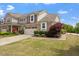 Attractive home exterior with lush green lawn, colorful flowers, and a two-car garage at 2737 Casper Creek Ln, Raleigh, NC 27616