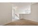 Upstairs hallway features neutral carpet and stairs leading down to a lower level at 2737 Casper Creek Ln, Raleigh, NC 27616