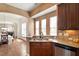 Stylish kitchen with hardwood floors, stainless steel appliances, custom cabinets, and eat in breakfast bar at 2737 Casper Creek Ln, Raleigh, NC 27616