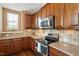 Classic kitchen with stainless steel range and microwave, and hardwood cabinets and backsplash at 2737 Casper Creek Ln, Raleigh, NC 27616