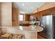 Stylish kitchen with hardwood floors, stainless steel appliances, custom cabinets, and eat in breakfast bar at 2737 Casper Creek Ln, Raleigh, NC 27616