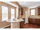 Bright kitchen features dark wood cabinets, granite countertops, hardwood floors, and eat-in breakfast bar at 2737 Casper Creek Ln, Raleigh, NC 27616