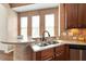 Kitchen view showcasing stainless steel sink, modern countertops, and breakfast bar at 2737 Casper Creek Ln, Raleigh, NC 27616