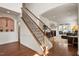 Elegant staircase with hardwood floors, ornate iron railings, and natural light at 2737 Casper Creek Ln, Raleigh, NC 27616