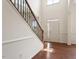 Bright foyer with wood floors and staircase with natural light shining through at 2737 Casper Creek Ln, Raleigh, NC 27616