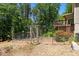 Backyard featuring custom wooden gate, raised garden beds, and deck at 3005 Buckhorn Rd, Sanford, NC 27330