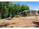 Backyard featuring patio set, custom wooden gate, raised garden beds, and deck at 3005 Buckhorn Rd, Sanford, NC 27330