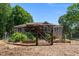 Backyard featuring custom wooden gate, raised garden beds, and deck at 3005 Buckhorn Rd, Sanford, NC 27330
