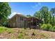 Backyard featuring custom wooden gate, raised garden beds, and deck at 3005 Buckhorn Rd, Sanford, NC 27330