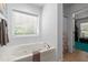 Bright bathroom features a luxurious soaking tub with jets and a large window, creating a relaxing atmosphere at 3005 Buckhorn Rd, Sanford, NC 27330