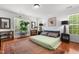 Cozy bedroom with hardwood floors, large windows, and neutral decor at 3005 Buckhorn Rd, Sanford, NC 27330