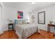 Comfortable bedroom featuring a well-made bed, hardwood floors, and natural light at 3005 Buckhorn Rd, Sanford, NC 27330