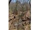 A tranquil creek flows through the property, adding natural beauty and recreational appeal at 3005 Buckhorn Rd, Sanford, NC 27330