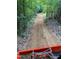 A well-maintained dirt road passes through a secluded, wooded area, showcasing the property's infrastructure at 3005 Buckhorn Rd, Sanford, NC 27330
