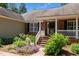 Charming brick home with well-manicured landscaping, a welcoming front porch, and classic black shutters at 3005 Buckhorn Rd, Sanford, NC 27330