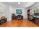 Spacious home office featuring hardwood floors, large desk, comfortable office chairs, and natural light at 3005 Buckhorn Rd, Sanford, NC 27330