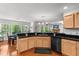 Open-concept kitchen with breakfast bar, stainless steel dishwasher, maple cabinetry and access to dining area and living room at 3005 Buckhorn Rd, Sanford, NC 27330