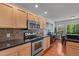 Beautiful kitchen with stainless steel appliances, maple cabinetry, backsplash and access to the dining area at 3005 Buckhorn Rd, Sanford, NC 27330