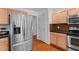 Kitchen featuring stainless steel refrigerator, maple cabinets, and access to adjoining rooms at 3005 Buckhorn Rd, Sanford, NC 27330