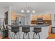 Modern kitchen featuring a breakfast bar with pendant lighting, stainless steel appliances, and ample cabinet space at 3005 Buckhorn Rd, Sanford, NC 27330