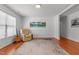 Cozy living room with hardwood floors, a comfortable recliner, and natural light from a large window at 3005 Buckhorn Rd, Sanford, NC 27330