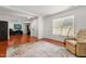 Cozy living room with hardwood floors, a large window, and a comfortable armchair at 3005 Buckhorn Rd, Sanford, NC 27330