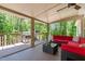 Covered patio featuring a grill and comfortable seating, perfect for outdoor entertaining and relaxation at 3005 Buckhorn Rd, Sanford, NC 27330