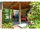 Covered outdoor patio features hammocks and seating area with steps to backyard at 3005 Buckhorn Rd, Sanford, NC 27330