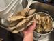 Freshly harvested mushrooms fill a colander and hand in this rustic kitchen scene at 3005 Buckhorn Rd, Sanford, NC 27330