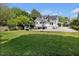 Expansive backyard with lush green grass, a swing, and a basketball hoop at 310 Henderson St, Oxford, NC 27565