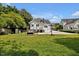 Expansive backyard with lush green grass, a swing, and a basketball hoop at 310 Henderson St, Oxford, NC 27565