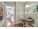 Sunny breakfast nook with a round table and views of the surrounding greenery at 310 Henderson St, Oxford, NC 27565