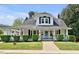 Charming home with a covered front porch, manicured lawn, and classic architectural details at 310 Henderson St, Oxford, NC 27565