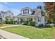 Inviting home featuring a spacious front porch, lush greenery, and classic design elements at 310 Henderson St, Oxford, NC 27565