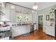 Charming kitchen featuring white cabinets, granite countertops, and stainless steel appliances at 310 Henderson St, Oxford, NC 27565