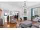 Bright living room with hardwood floors, fireplace, and an inviting open layout to other rooms at 310 Henderson St, Oxford, NC 27565
