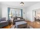 Bright living room featuring hardwood floors, large windows, and neutral-toned furniture at 310 Henderson St, Oxford, NC 27565