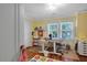 Bright office with wood floors, yellow walls, natural light, and a desk at 310 Henderson St, Oxford, NC 27565
