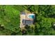 Beautiful aerial view of a home with a pool surrounded by lush greenery and mature trees at 318 Hepowil Trce, Hillsborough, NC 27278