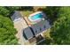 Stunning aerial view of a home with a sparkling pool, lush green landscaping, and a detached garage at 318 Hepowil Trce, Hillsborough, NC 27278
