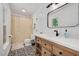 Bright bathroom with modern vanity, decorative mirror, and patterned tile flooring at 318 Hepowil Trce, Hillsborough, NC 27278