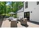 Spacious outdoor deck with stylish patio furniture and elegant umbrella seating area at 318 Hepowil Trce, Hillsborough, NC 27278