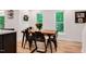 Cozy dining room with wood table, black chairs, and large windows providing natural light at 318 Hepowil Trce, Hillsborough, NC 27278