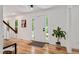 Inviting foyer with wood floors, a front door with sidelights, and staircase leading to the second floor at 318 Hepowil Trce, Hillsborough, NC 27278