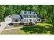 Attractive two-story home with a lush lawn, manicured landscaping, and an attached two car garage at 318 Hepowil Trce, Hillsborough, NC 27278