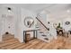 Charming foyer with hardwood floors, a staircase, and a round mirror offering a welcoming ambiance at 318 Hepowil Trce, Hillsborough, NC 27278