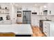 Modern white kitchen with stainless steel appliances, quartz countertops, and custom cabinetry at 318 Hepowil Trce, Hillsborough, NC 27278