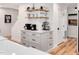 A kitchen featuring a built-in coffee bar, open shelving, white subway tile, and light gray cabinets at 318 Hepowil Trce, Hillsborough, NC 27278